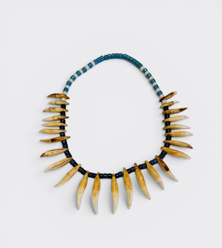 M 556 AG glass necklace and bear claw, early 20th century 