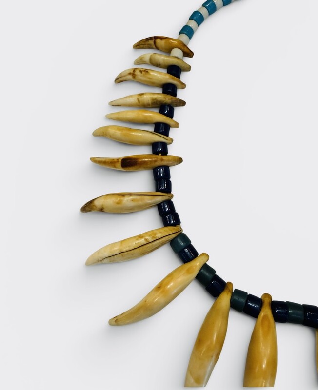 M 556 AG glass necklace and bear claw, early 20th century 