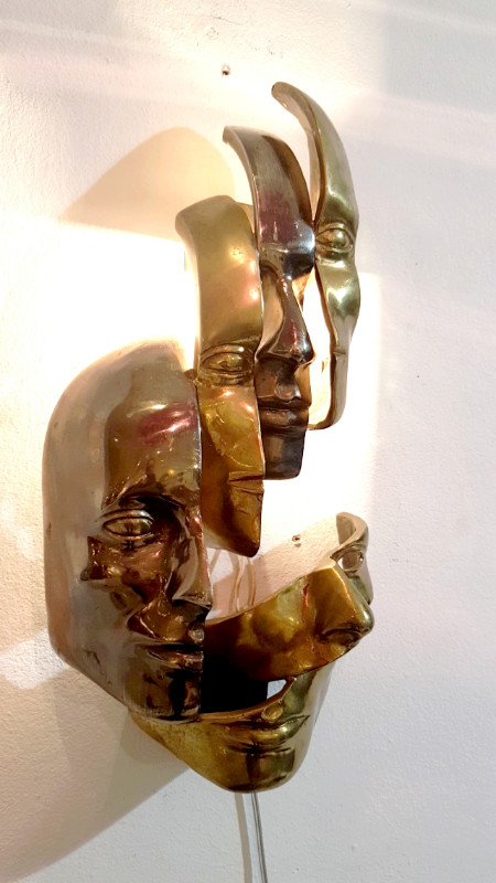M 74 AV Lighted wall sculpture in the manner of Arman. Bronze with two patinas. Ca. 1980