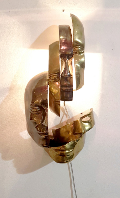 M 74 AV Lighted wall sculpture in the manner of Arman. Bronze with two patinas. Ca. 1980
