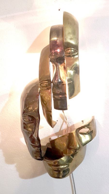M 74 AV Lighted wall sculpture in the manner of Arman. Bronze with two patinas. Ca. 1980