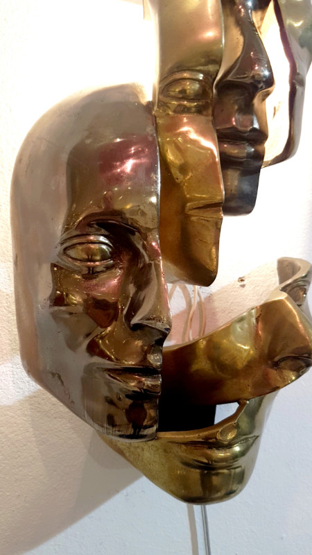 M 74 AV Lighted wall sculpture in the manner of Arman. Bronze with two patinas. Ca. 1980